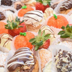 Catering from Goodies Bakeshop Fancy French Pastry Tray: Assortment of cannoli, cream puffs, chocolate eclairs, peaches, truffles and slices